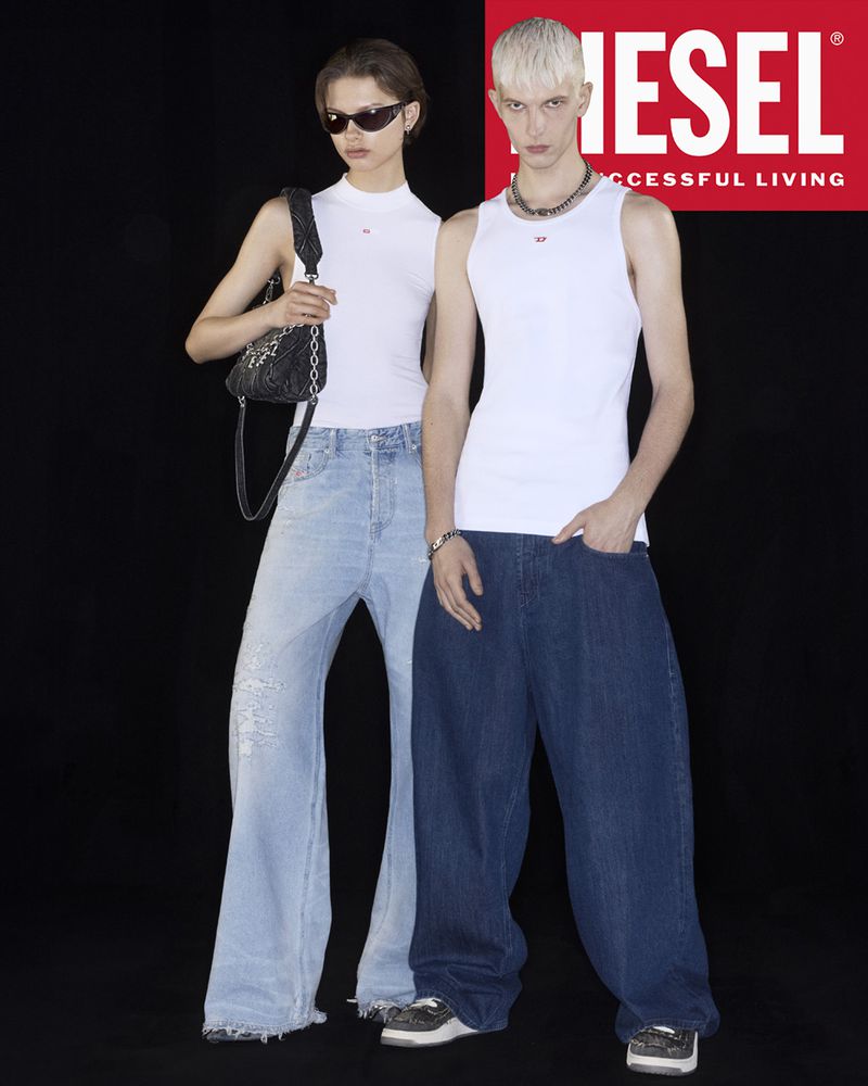 Two fashion models in white tank tops and baggy jeans pose in a photo studio against a black backdrop with a red Diesel logo.