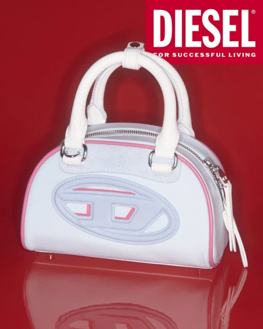 Close-up of a Diesel handbag with white handles and pale-blue body. The brand's iconic 'D' logo is prominently featured, against a red backdrop.