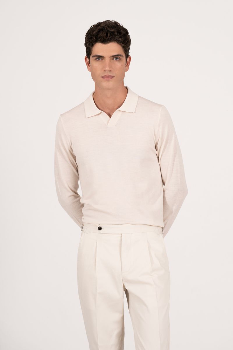 Model Lucas Prada in an off-white collared polo and matching trousers against a clean white background for the Aralu project.