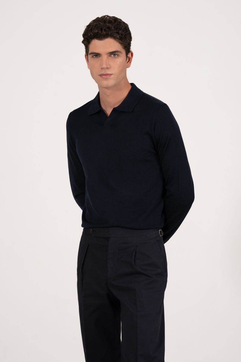 Model wearing a dark navy polo shirt and dark trousers against a plain light background for Aralu