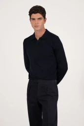 Model wearing a dark navy polo shirt and dark trousers against a plain light background for Aralu