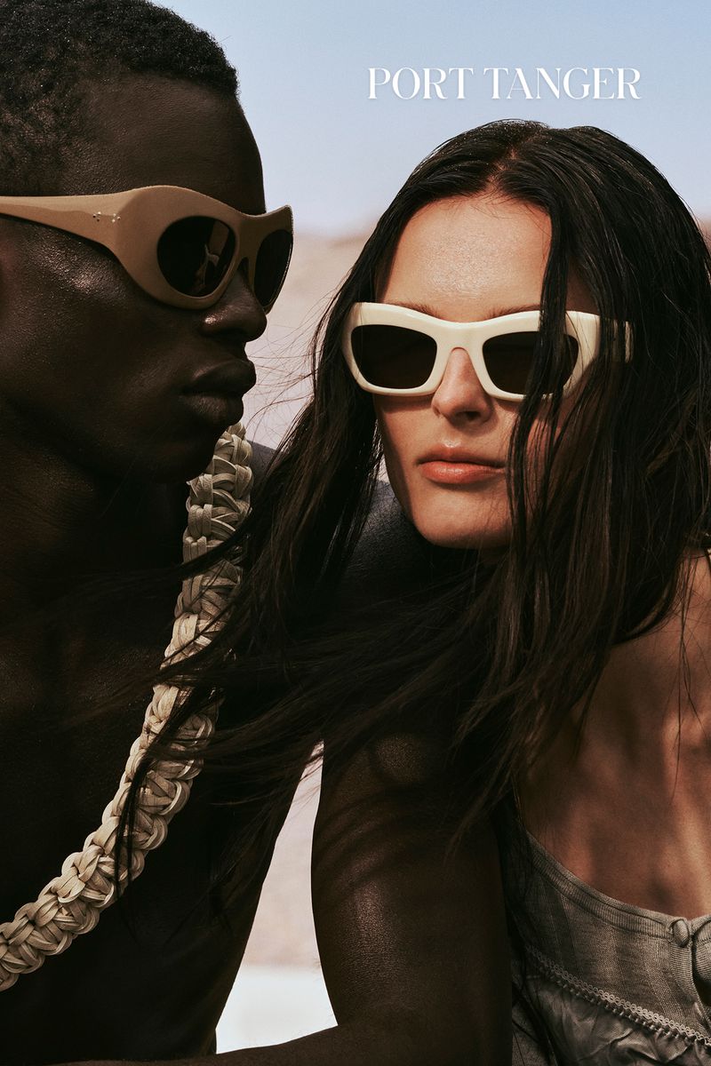Two models wearing fashion sunglasses in an outdoor setting. The sunglasses are different shapes and colors, with a desert background.