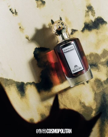 Penhaligon's Portraits Duchess Rose perfume bottle with a cat head cap on a marbled surface with a shadow. Beauty and personal care ad.