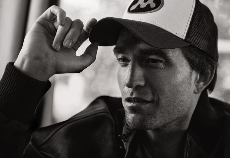 Portrait of Robert Pattinson wearing a trucker hat and jacket for V Magazine Screen Stories by photographer Cass Bird.