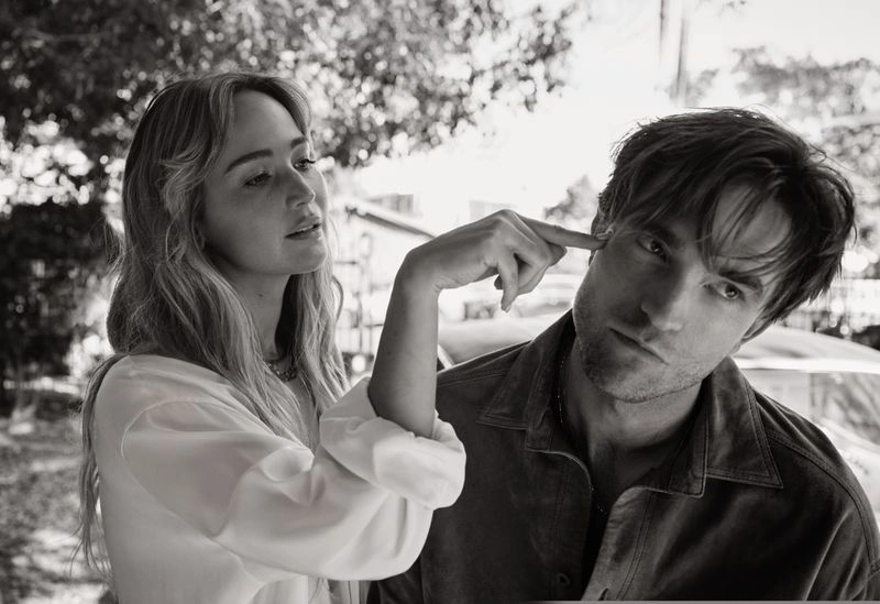 Black and white portrait of Jennifer Lawrence pointing at Robert Pattinson outdoors for V Magazine
