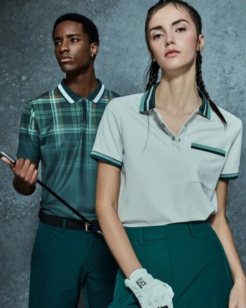 Two fashion models in polo shirts and golf attire pose against a mottled gray backdrop, showcasing apparel for an athletic lifestyle brand.