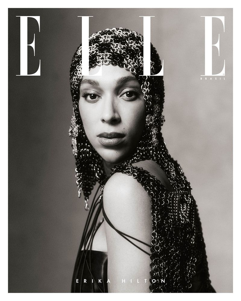 Elle Brasil cover features Erika Hilton in a metallic headpiece and black top, shot in black and white against a plain background.