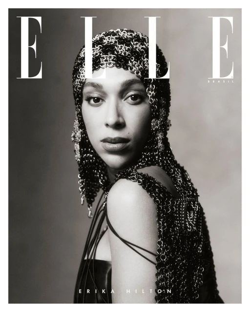 Elle Brasil cover features Erika Hilton in a metallic headpiece and black top, shot in black and white against a plain background.