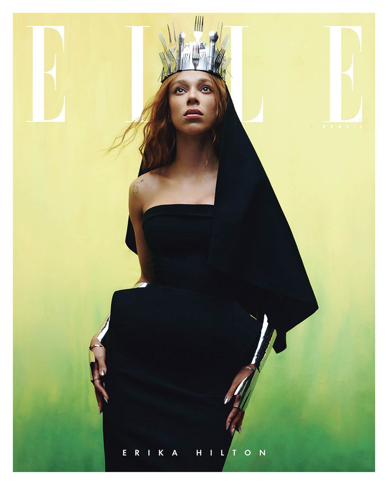 Erika Hilton on magazine cover, wearing black dress and crown made of silverware, against gradient yellow and green background.