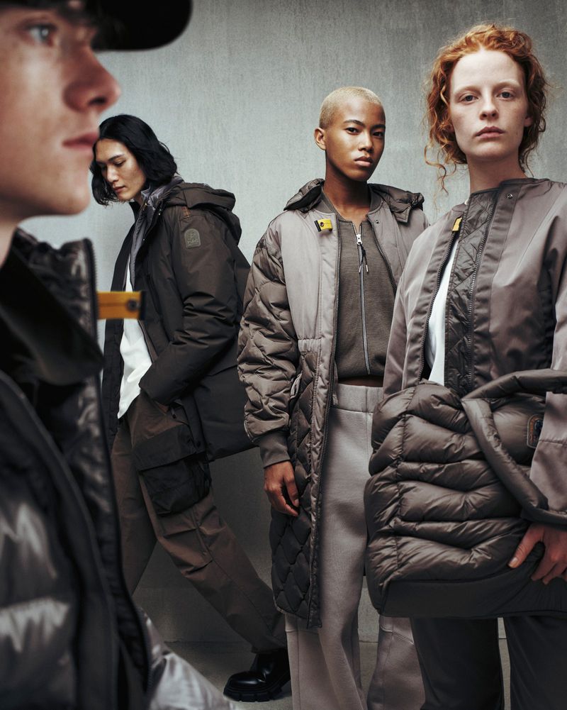 Four models in winter outerwear posing against a neutral textured studio background for Parajumpers F/W 25.