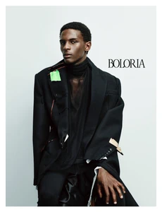 Model in black blazer and turtleneck against white backdrop for Boloria collection