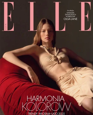 Model Olga Lane posing on a red beanbag wearing a beige halter top and skirt for Elle Poland March Issue 2025.