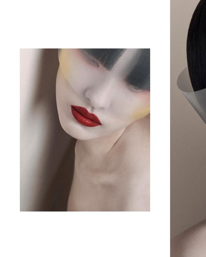 Artistic close-up of a woman's face with dramatic makeup and a transparent mesh veil, creating a surreal, high-fashion aesthetic.