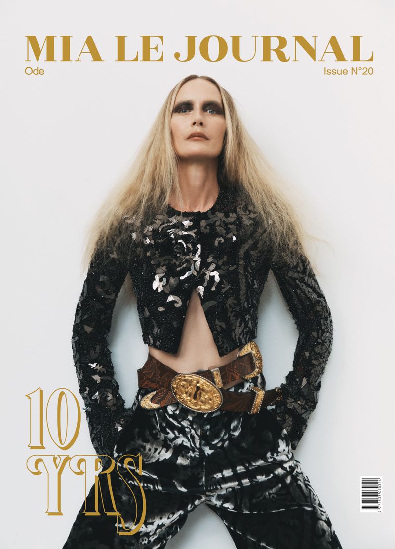 Blonde model in a cropped sequin jacket, patterned trousers, and a wide gold buckle belt on the Mia Le Journal Issue 20 cover.
