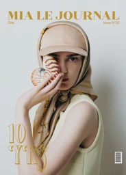 Model wearing a baseball cap, headscarf, and seashell covering part of her face for Mia Le Journal