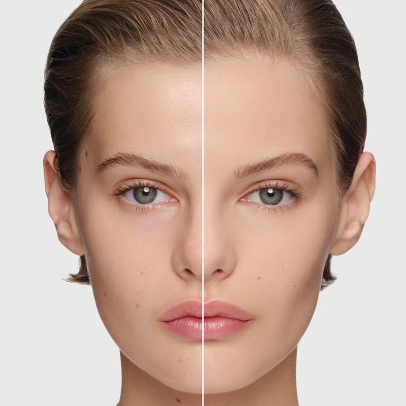 Close-up of a woman's face showing a before-and-after comparison of makeup application on her face against a light background.