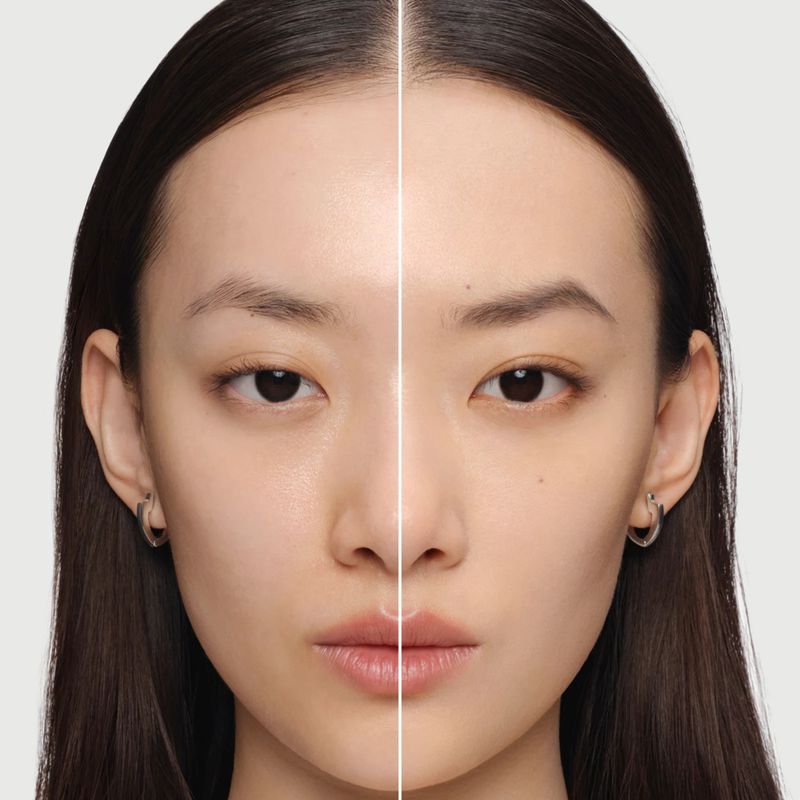 Asian woman's face, showcasing before-and-after makeup results with a clear dividing line; beauty shot for makeup demonstration.
