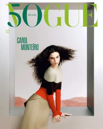 Vogue Brasil cover featuring Carol Monteiro with dark, wavy hair in a color-blocked top and long skirt, posing by a window-like frame.
