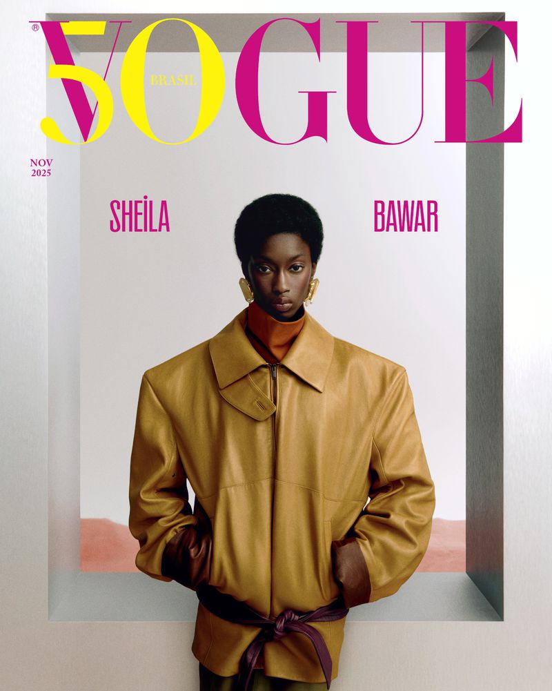 Vogue Brasil cover featuring Sheila Bawar wearing a tan jacket, earrings, and a turtleneck against a white and peach background.