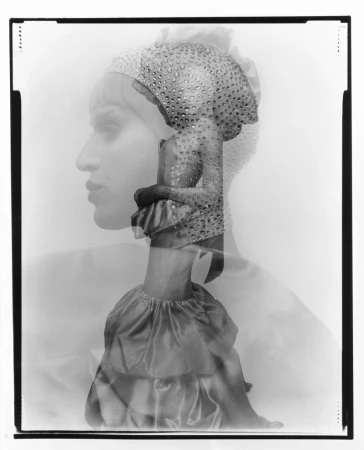 Monochrome double exposure of a woman in profile and a woman in a dress and sequined hat in a studio setting.