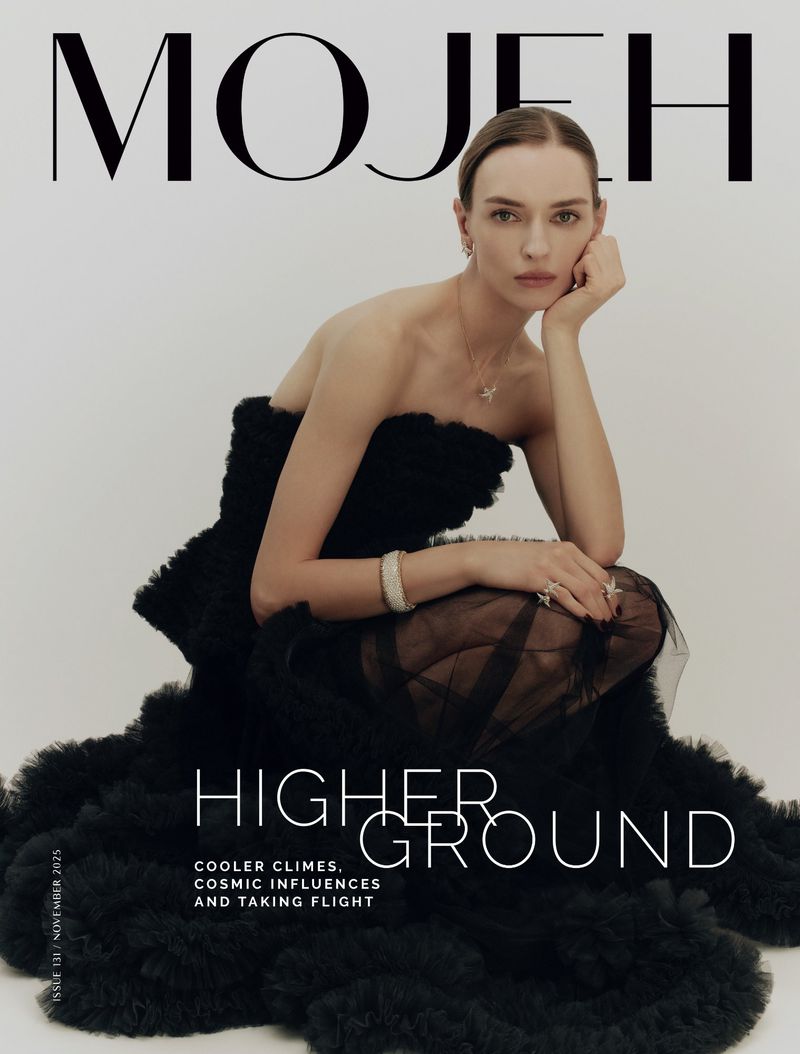 Magazine cover featuring a woman in a black strapless dress with a ruffled skirt, posing against a white background with the text 'MOJEH'.