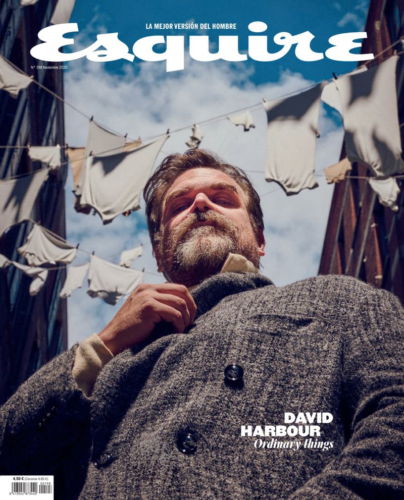 Esquire magazine cover featuring David Harbour in gray tweed jacket, laundry lines overhead, blue sky, capturing urban editorial style.