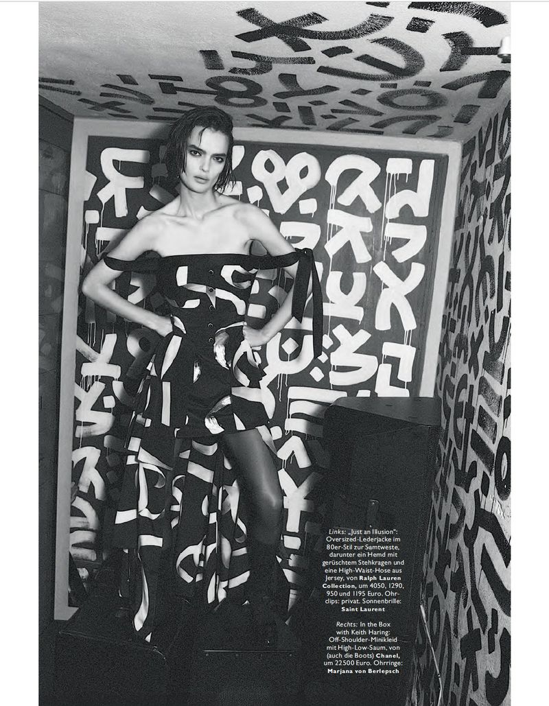 Fashion editorial shot of a model in a black-and-white dress, standing in a room with graffiti art, creating a bold and artistic composition.