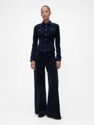 Model wearing a dark blue corduroy jacket and matching wide-leg trousers against a plain white background.