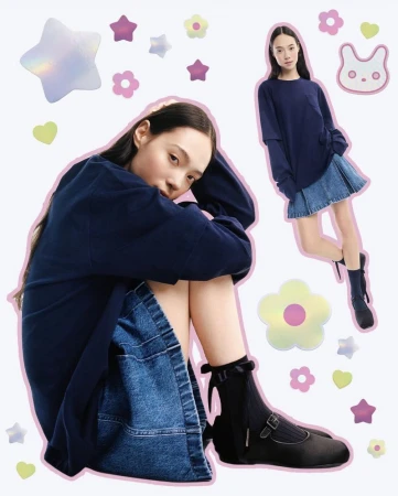 Two young women pose in navy tops and denim skirts with holographic flower stickers on a light background in a fashion-style image.