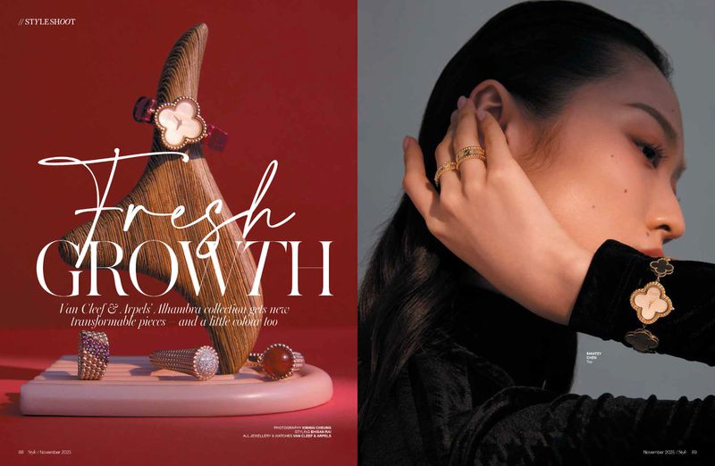 Editorial layout features model with Van Cleef & Arpels Alhambra jewelry, rings, and watch against red and grey backdrop in close-up studio shot.