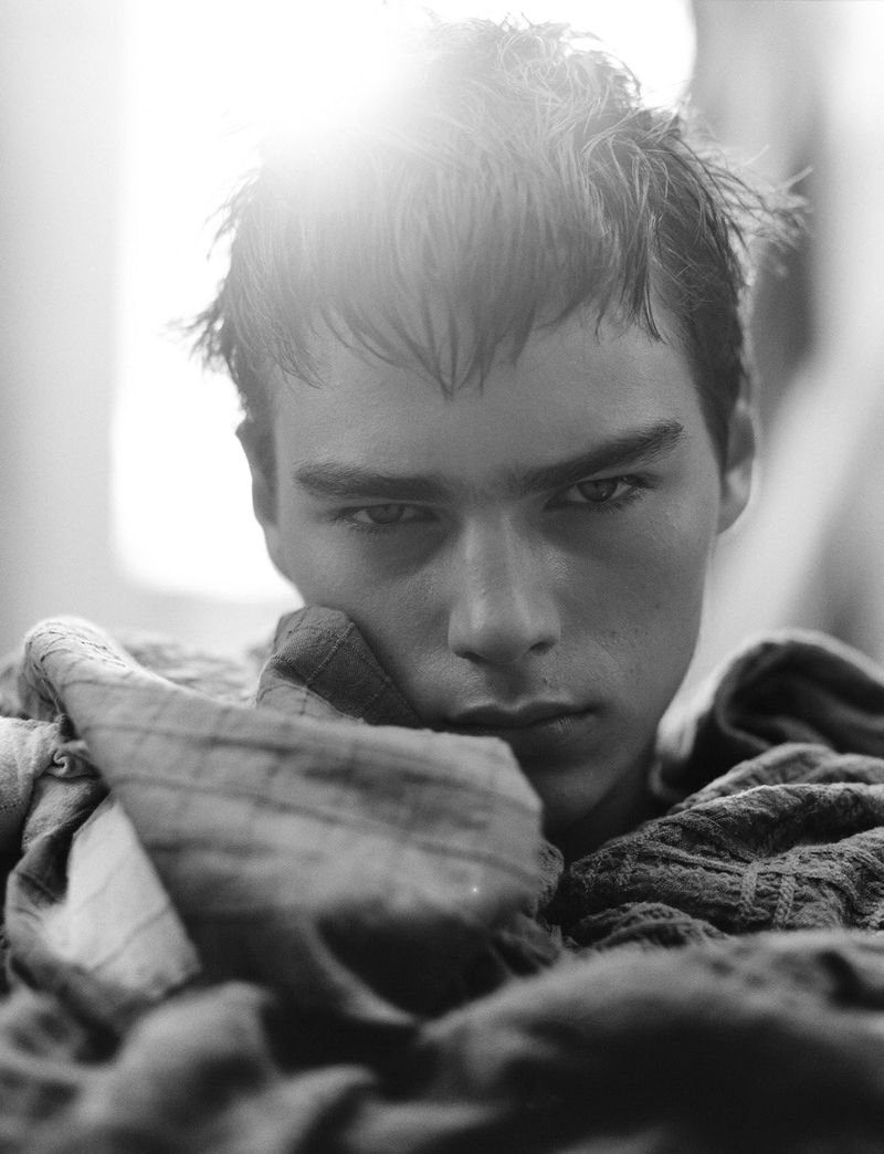 Close-up portrait of a young man with wet hair and a textured garment wrapped around his neck for Dapper Dan Magazine.