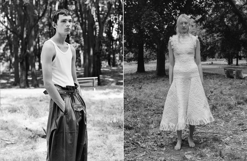 Two fashion models pose outdoors, one male in tank top and leather pants, one female in an eyelet dress. Black and white, outdoor lighting.