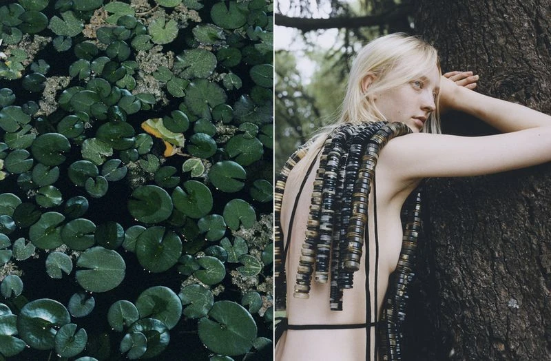 Fashion shot of a blonde female model in an outdoor environment, wearing a unique beaded garment, posing near a tree with lily pads in the background.