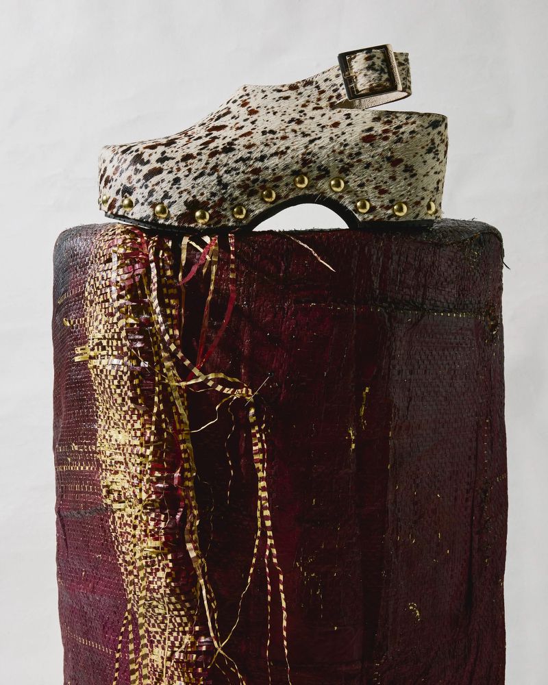Elevated view of platform shoe on woven base features brown and white speckled print with gold accents on a plain, neutral backdrop.