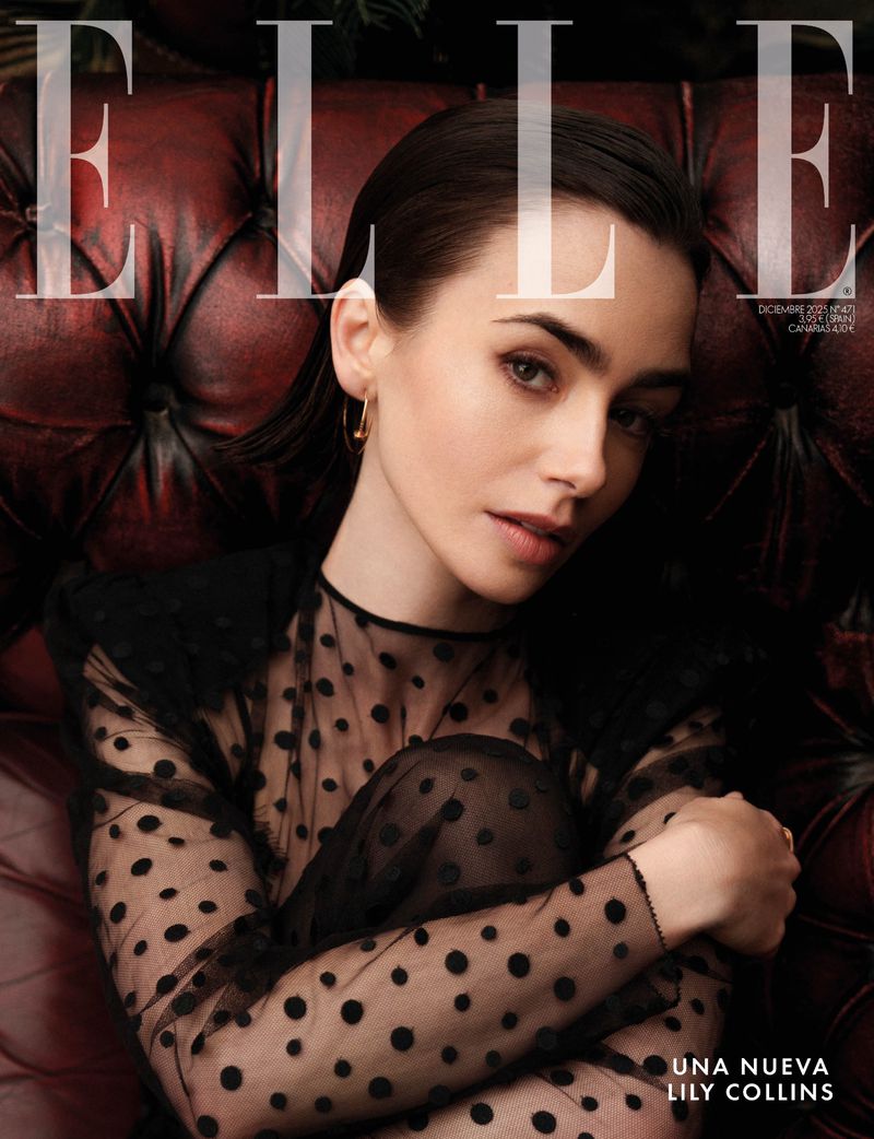 Lily Collins graces the cover of Elle magazine, seated on a red leather couch, wearing a sheer black polka dot dress. Editorial fashion shot.