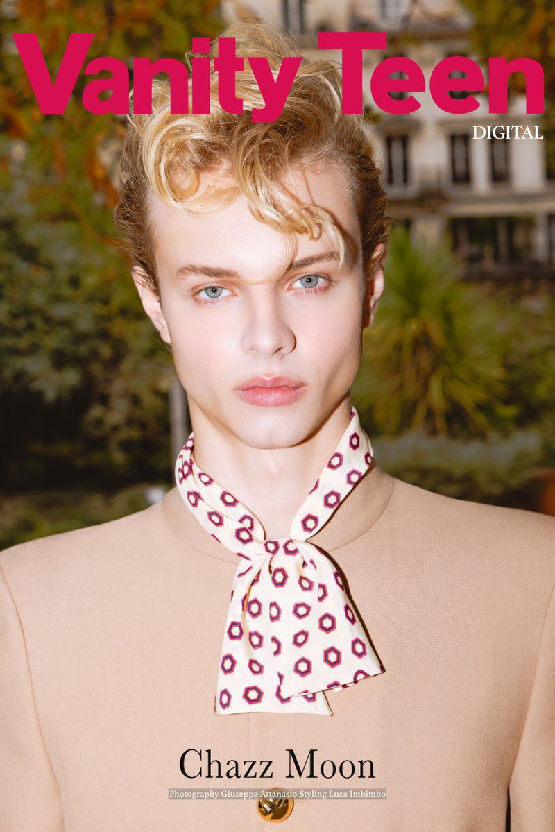 Teenage model Chazz Moon poses for a magazine cover wearing a tan suit jacket and patterned scarf in a close-up fashion shot.