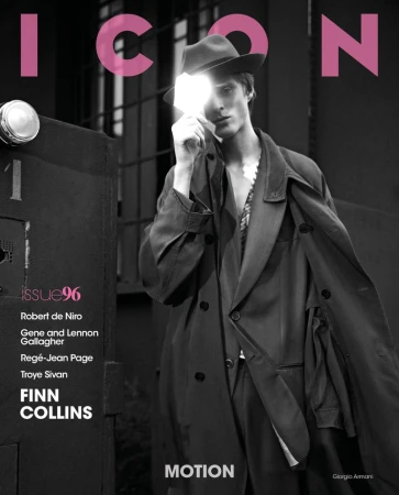Magazine cover featuring a male model in a hat and trench coat, standing near a door, with bright lighting and the ICON logo in pink.