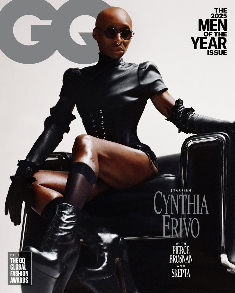 Cynthia Erivo poses on black chair for GQ magazine cover; she wears sunglasses, black corset top, gloves, boots, and dark stockings.