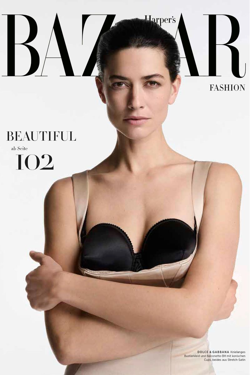 Harper's Bazaar magazine cover features a woman with arms crossed wearing a strapless top against a plain white backdrop.