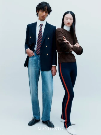 Two models posing against a white background in tailored fashion for Manifesto Magazine