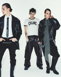 Three male models posing in black leather jackets, dark trousers, and a white Celine t-shirt against a plain white studio background.