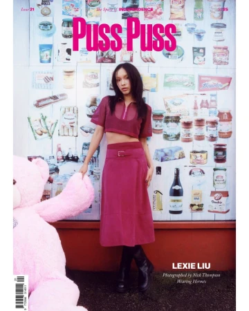 Lexie Liu poses in a magazine cover against a wall of food products, wearing a magenta top, skirt, and black boots, with a pink teddy bear.