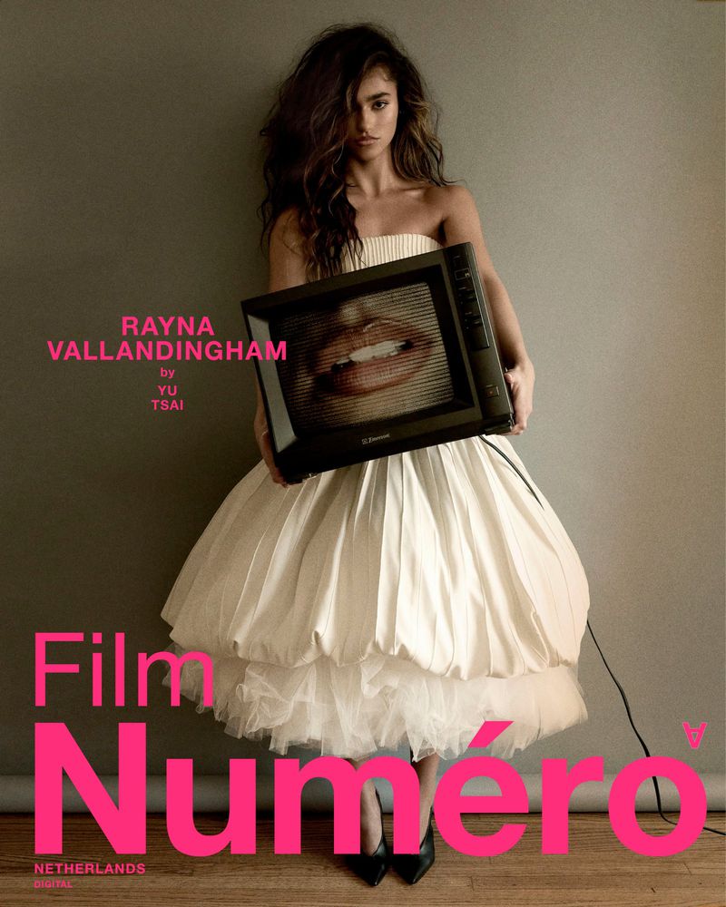 Fashion shot: Woman in a white dress holding a vintage television with lips displayed on the screen in a photo studio setting.