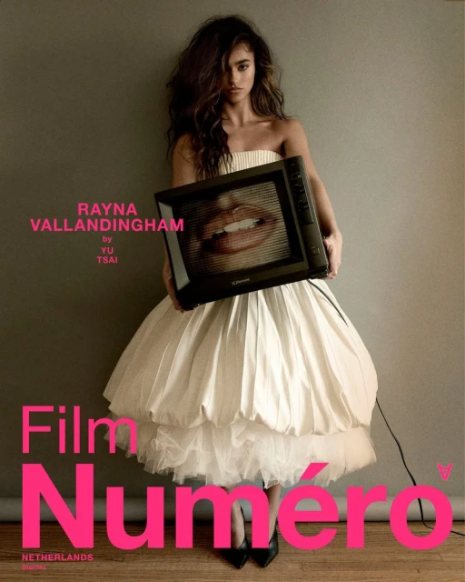 Fashion shot: Woman in a white dress holding a vintage television with lips displayed on the screen in a photo studio setting.