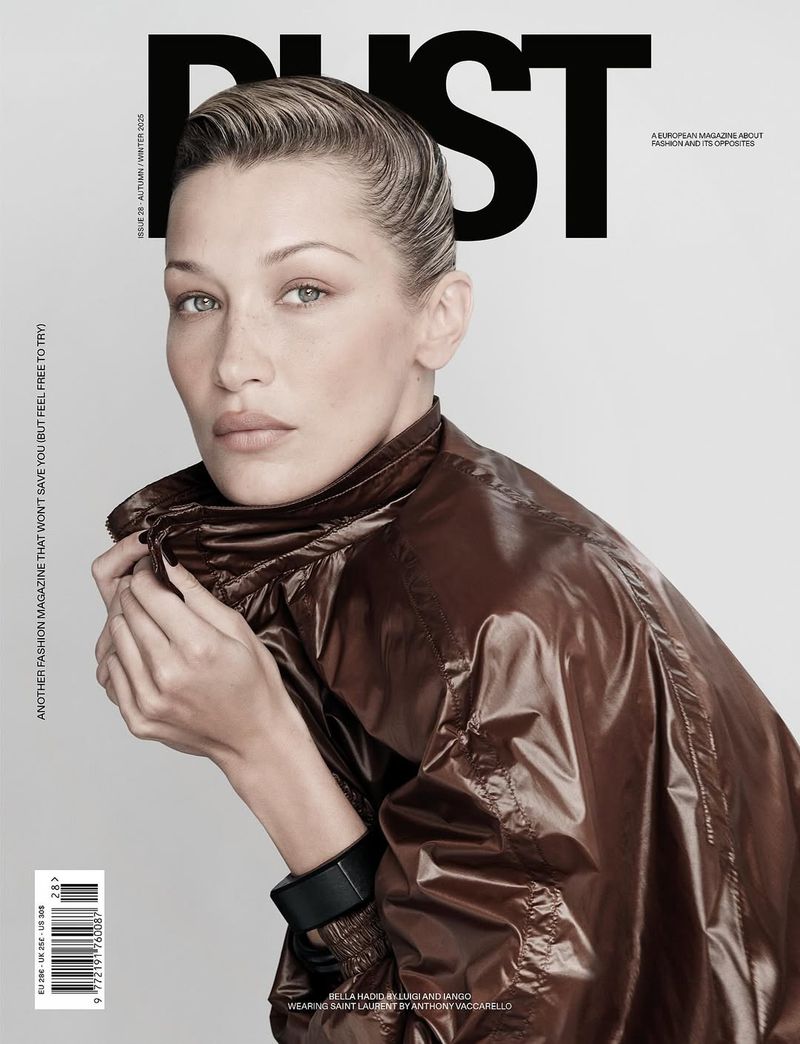 Magazine cover featuring a close-up of model Bella Hadid in a brown jacket, against a plain background with bold white text and logo.