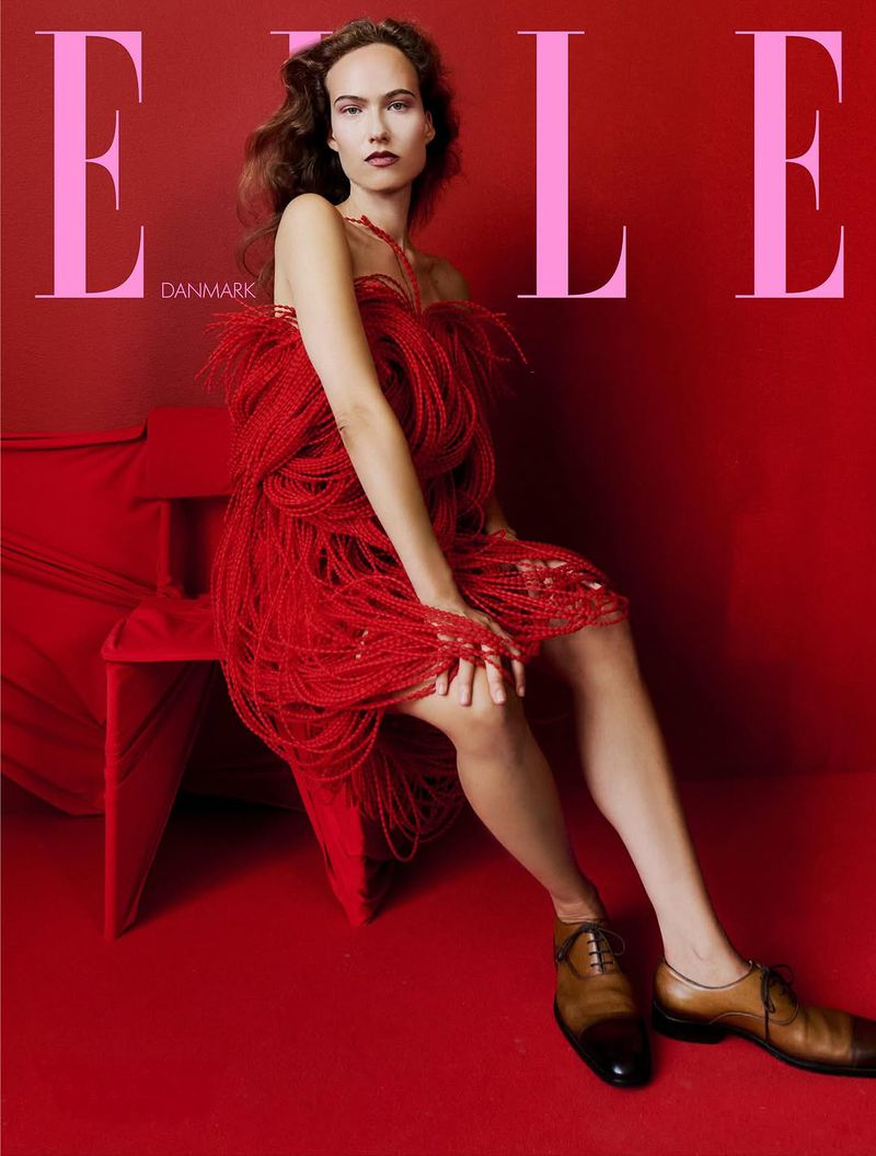 Elle Denmark cover featuring a woman in a unique red fringed dress sitting on a matching chair, set against a red backdrop.