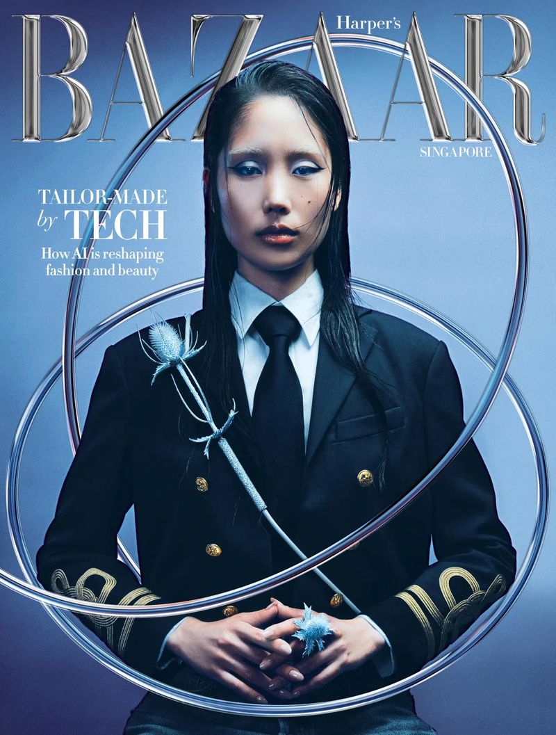 Harper's Bazaar Singapore cover featuring an Asian woman in a dark blazer and tie, surrounded by silver rings, set against a light blue background.