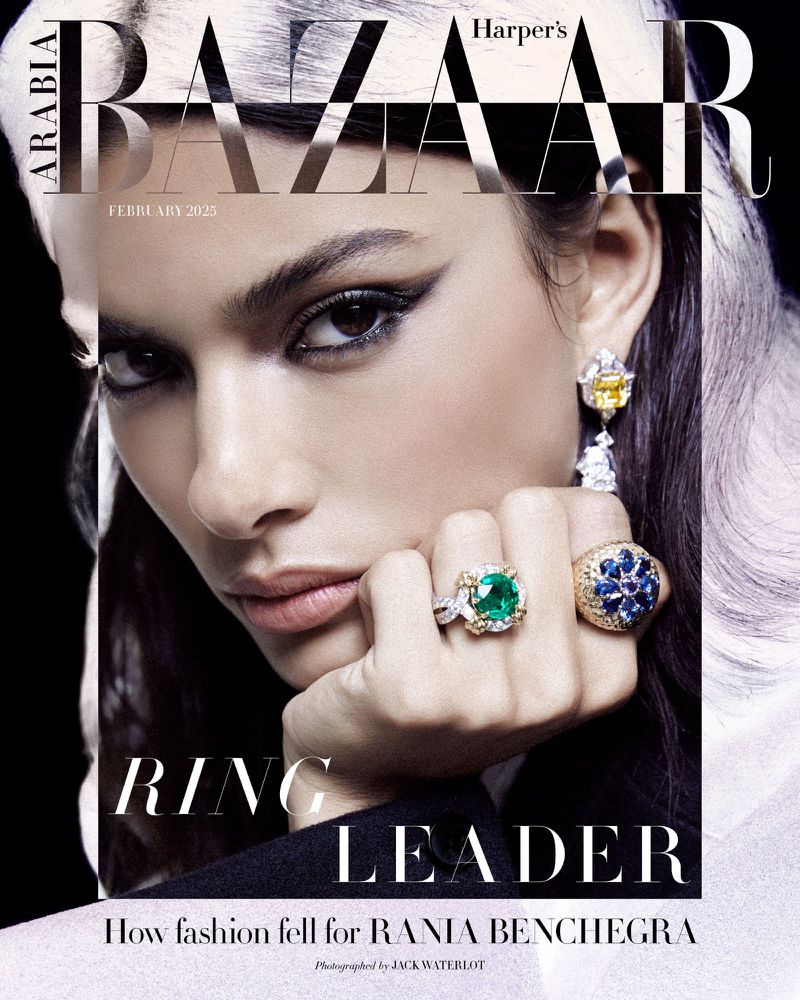 Close-up fashion magazine cover featuring a female model with bold eye makeup and jewelry, against a dark background, February 2023.