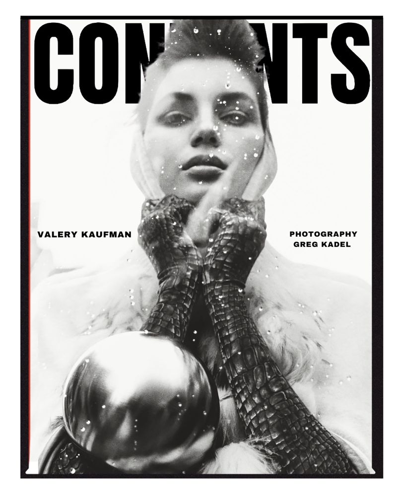 Black and white portrait of Valerie Kaufman on a magazine cover, wearing gloves and headscarf, holding a silver ornament.