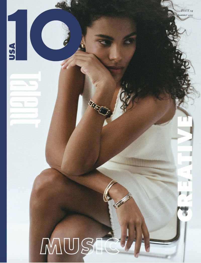 Magazine cover featuring a woman with curly hair in a sleeveless top and skirt, accessorized with bangles and a bracelet-style watch.